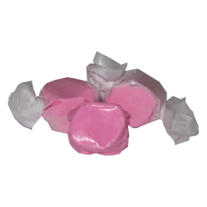 Two wrapped and one unwrapped piece of light pink Bubblegum salt water taffy