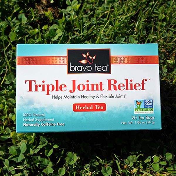 Bravo Triple Joint Relief Herbal Tea box lying on green clover