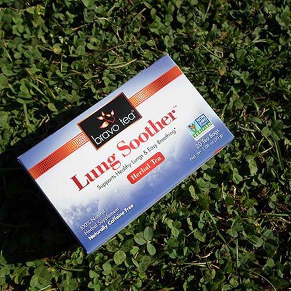 Bravo Tea Lung Soother herbal tea box tilted on green clover