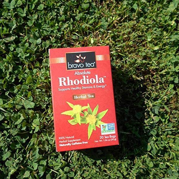 Bravo Tea Absolute Rhodiola box standing on green clover in sunlight