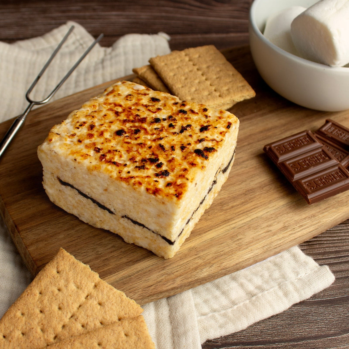 The Crispery S'mores Crispycake, Marshmallow Crispy Rice Treat styled on a table