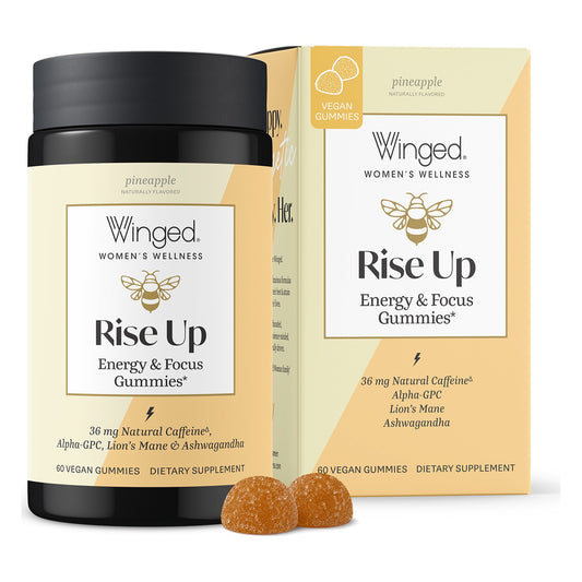 Winged Wellness Rise Up Energy & Focus Gummies jar in front of its pineapple-yellow box, labeled 36 mg natural caffeine and 60 vegan gummies, with two orange gummies