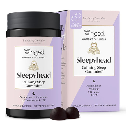 Winged Wellness Sleepyhead Calming Sleep Gummies jar in front of its lavender box, blueberry lavender flavor, 60 vegan gummies, with two dark purple gummies