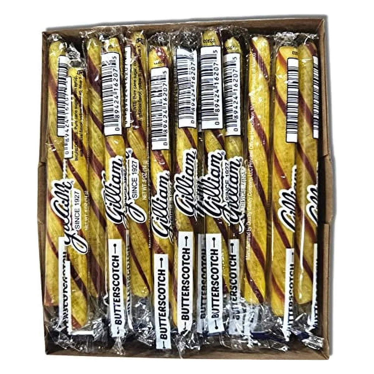 Open box of Gilliam Butterscotch stick candy seen from above: individually wrapped golden yellow sticks with brown stripes, wrappers printed Butterscotch and UPC 0 89424 16207 5