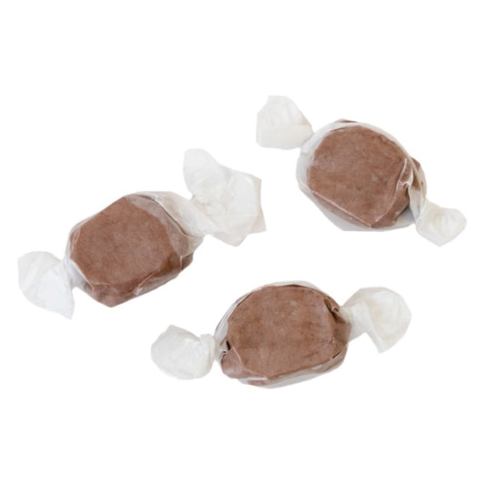 Three wrapped pieces of Sweet's Chocolate taffy in brown on a white background