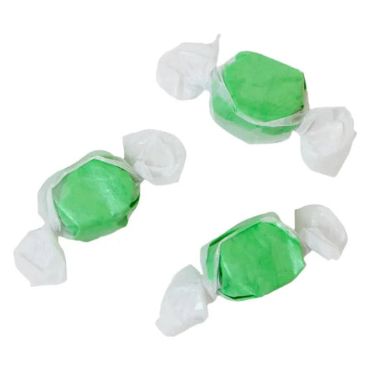 Three wrapped pieces of Sweet's Kiwi Coconut taffy in green on a white background