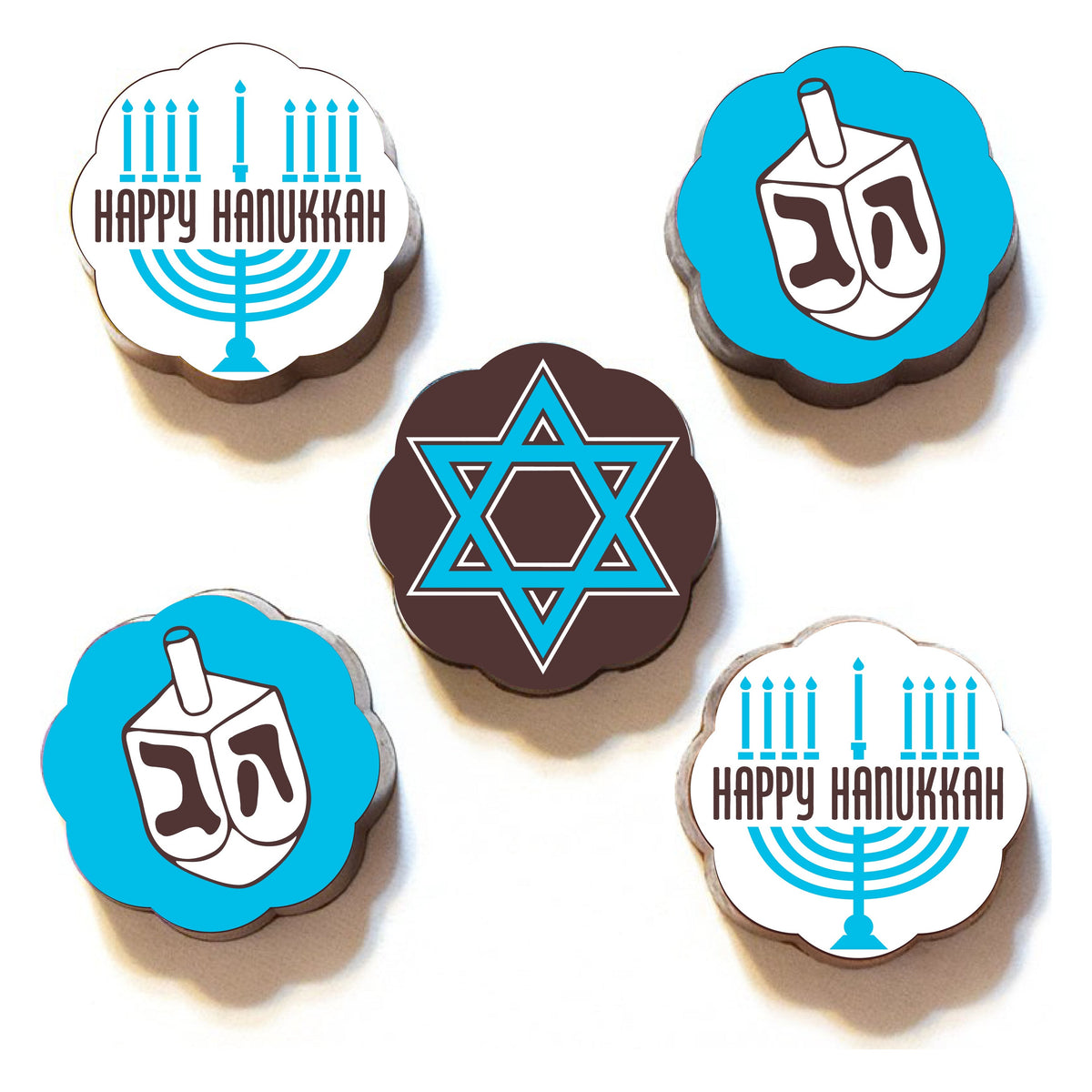 Five Chouquette Hanukkah chocolates on white: two Happy Hanukkah menorahs, two blue dreidels and a blue Star of David