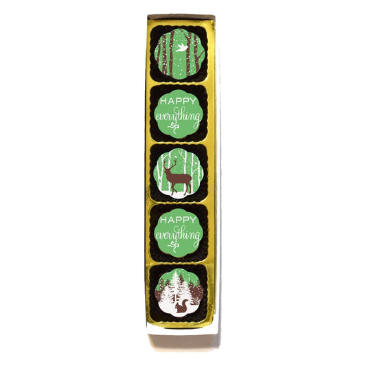 Box of 5 Chouquette Woodland Wonderland chocolates in a gold tray: bird in birch trees, deer, squirrel under snowy pines and two green Happy Everything pieces