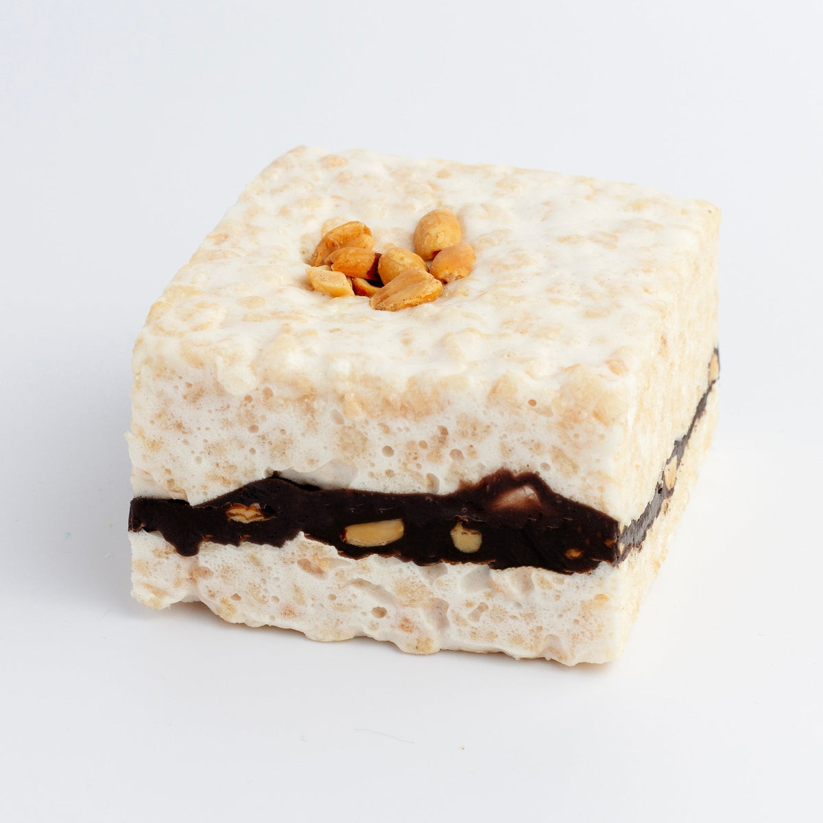 The Crispery Chocolate Caramel & Nuts Crispycake, warm-weather version: square marshmallow crispy rice treat with roasted peanuts on top and a chocolate, caramel and peanut layer through the middle