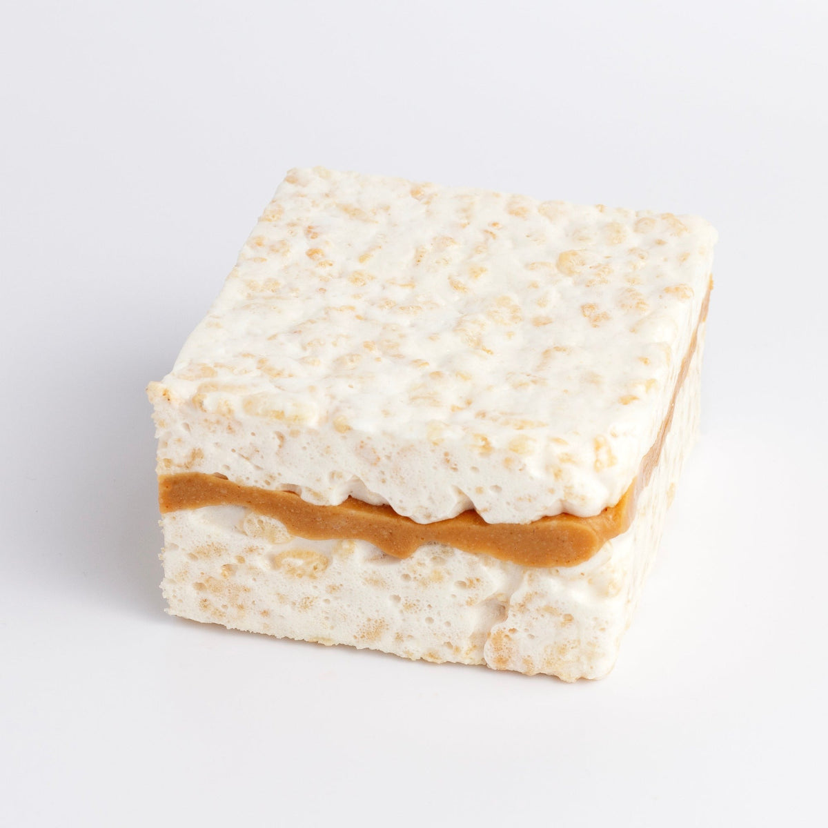 Peanut Butter Fluff Crispycake on a white background with a peanut butter layer through the middle