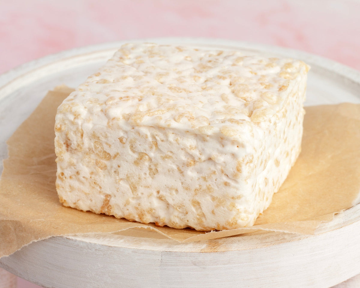 Plain & Sweet Crispycake on parchment on a white wooden board