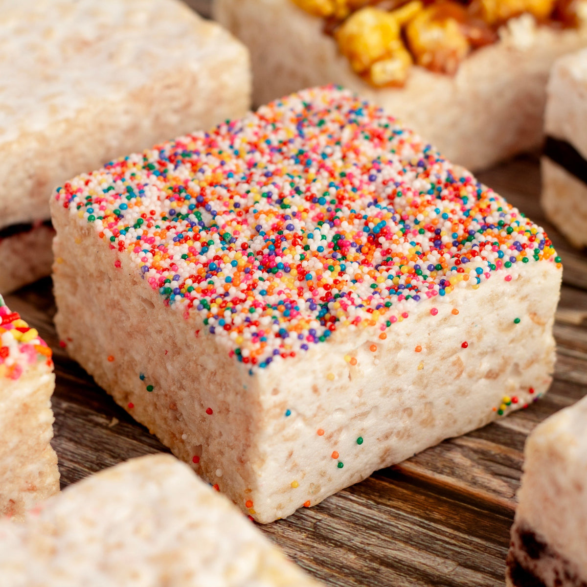Close view of a Rainbow Nonpareils Crispycake on a wooden table