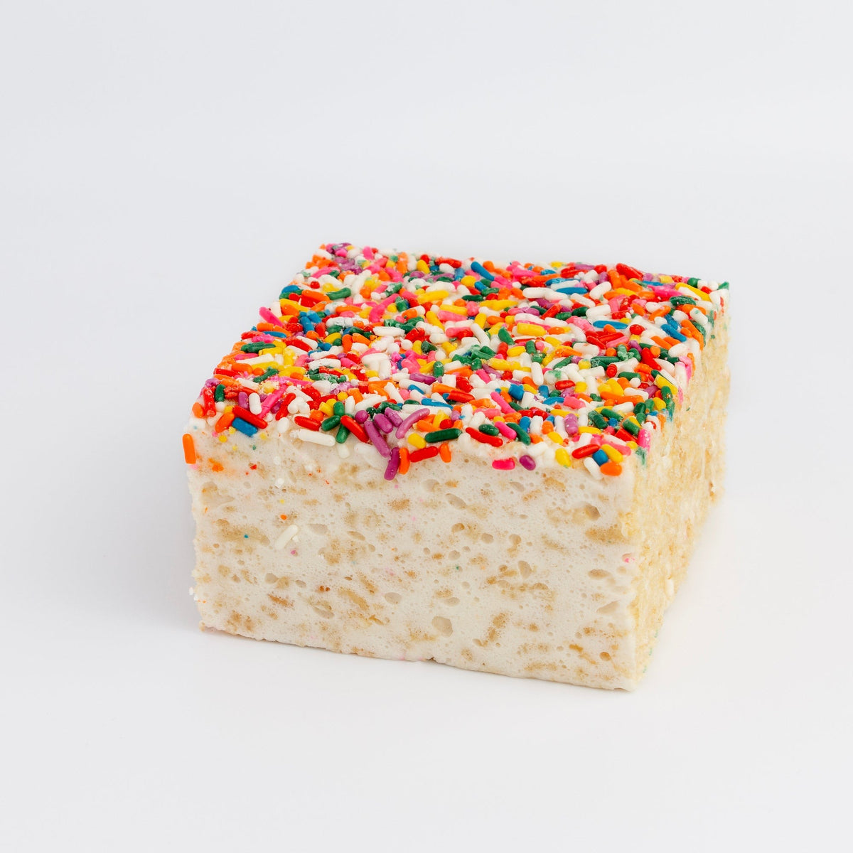 Rainbow Sprinkles Crispycake on a white background, top covered in multicolored rod sprinkles