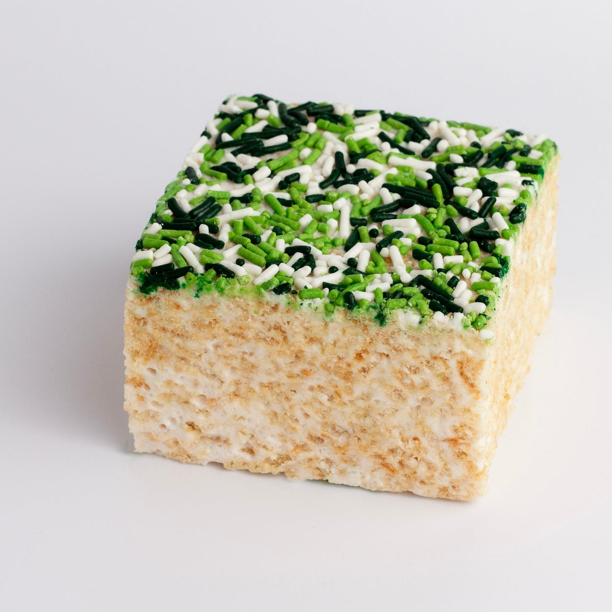 St. Patrick's Day Sprinkles Crispycake on a white background, top covered in light green, dark green and white sprinkles