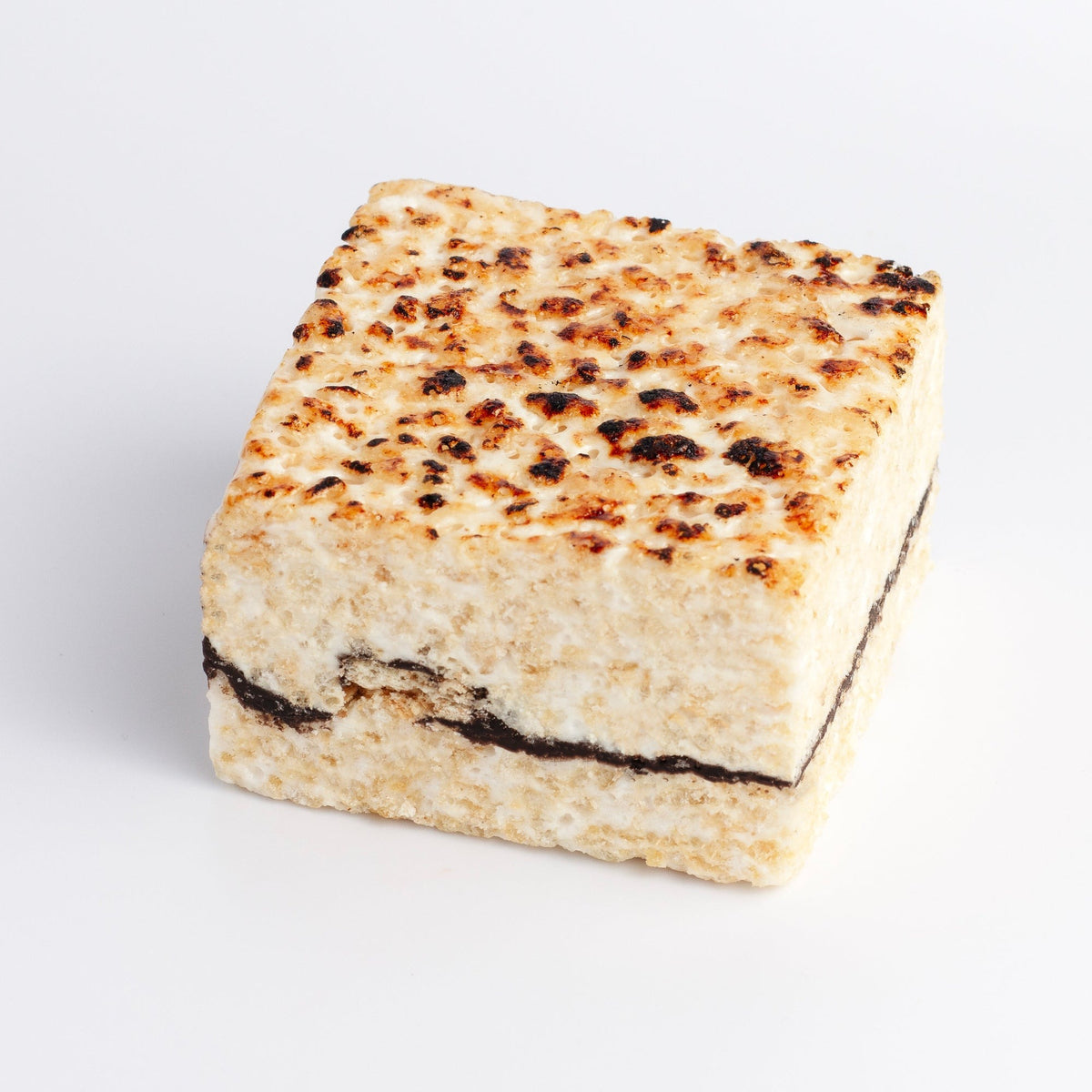 S'mores Crispycake on a white background with a toasted marshmallow top and a chocolate and graham cracker layer