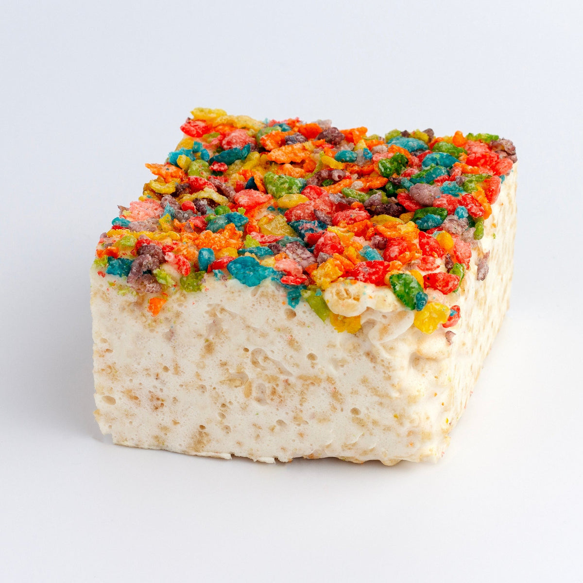 The Crispery Fruity Crispies Crispycake on a grey background, its top covered in multicolored fruity cereal flakes