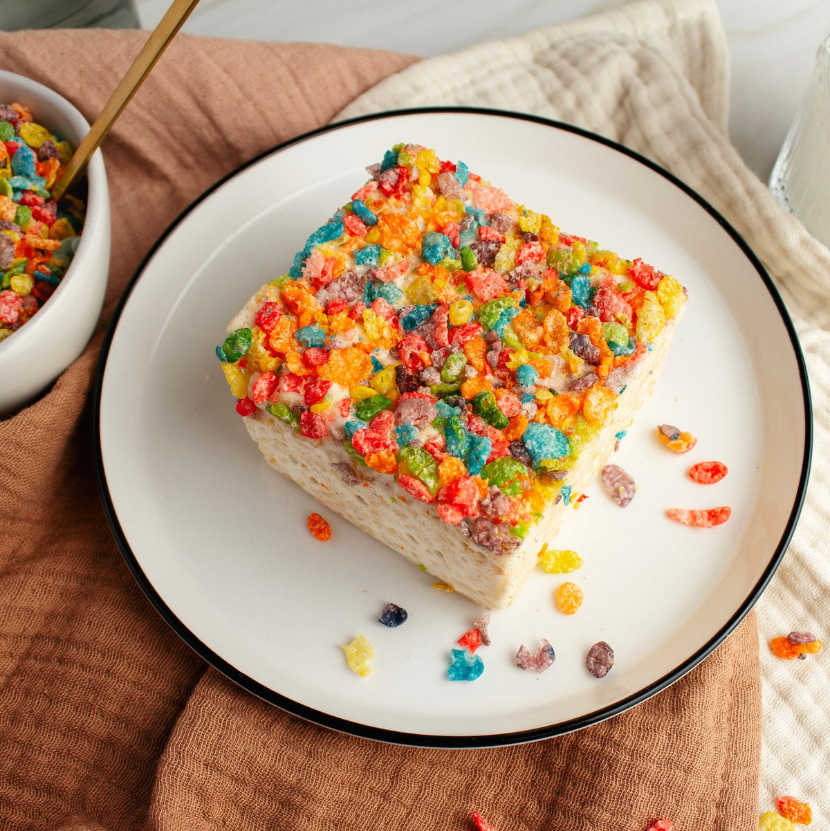 Overhead view of the Fruity Crispies Crispycake on a plate, showing the full cereal-covered top