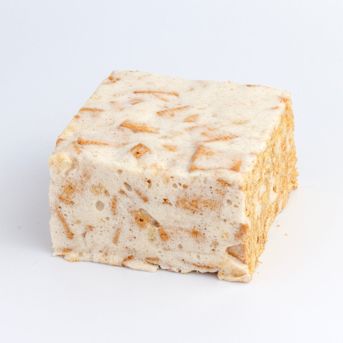 The Crispery Toasted Cinnamon Crispy Crispycake on a grey background, with cinnamon cereal pieces visible through the marshmallow