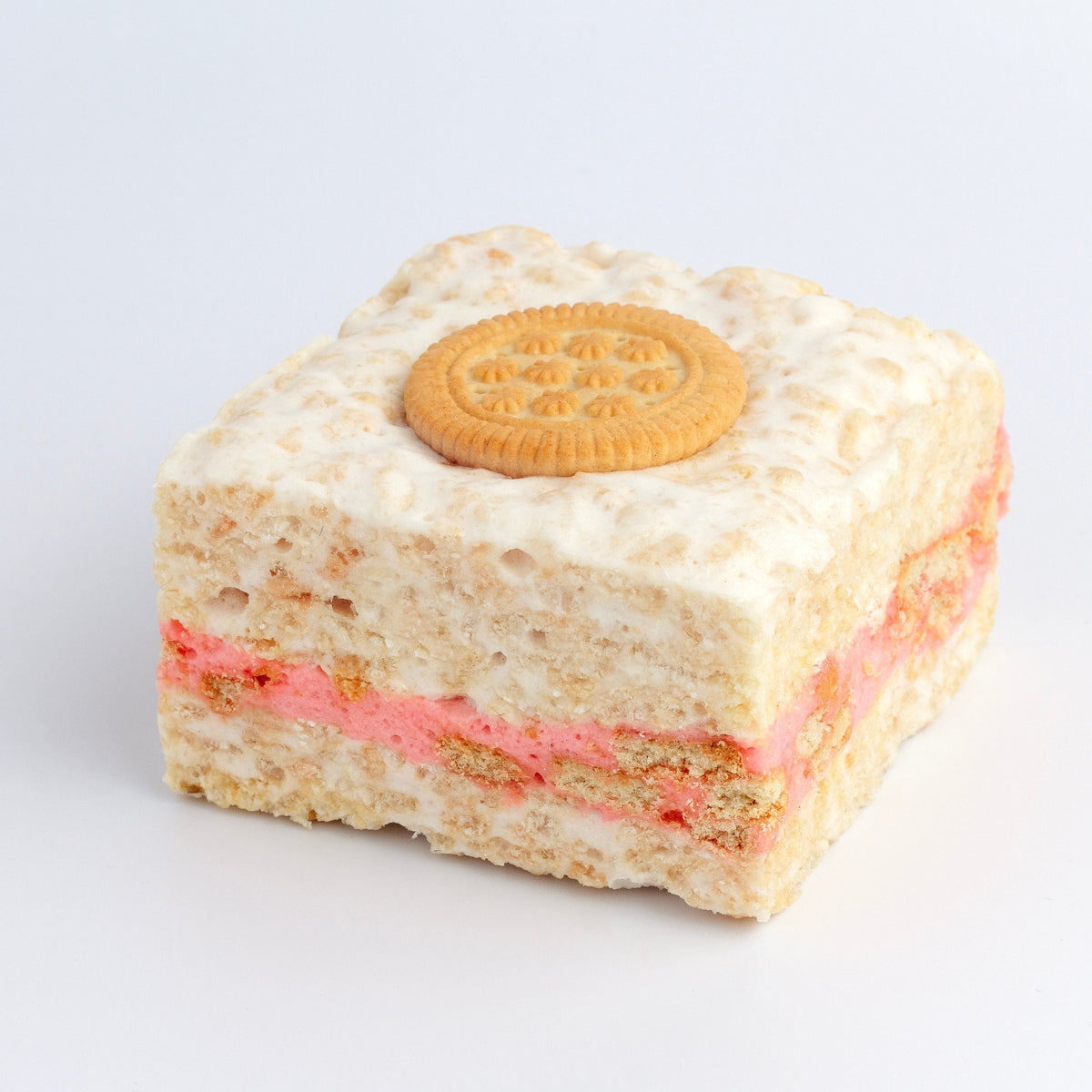 Strawberry Cookies & Cream Crispycake on a white background showing the pink strawberry cream layer and a round cookie on top