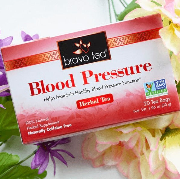 Bravo Blood Pressure Herbal Tea box lying among pink, yellow and purple flowers