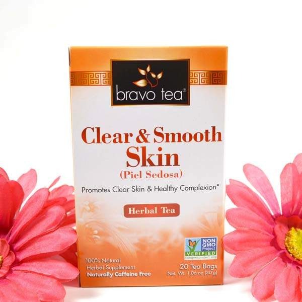 Bravo Tea Clear & Smooth Skin box standing between pink gerbera daisies