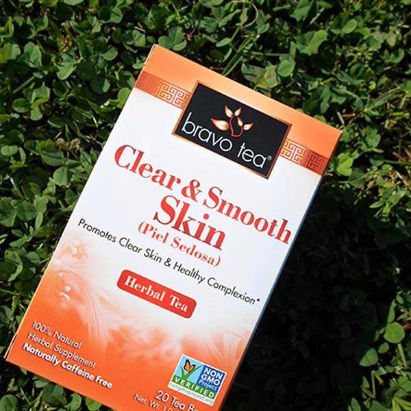 Bravo Tea Clear & Smooth Skin herbal tea box tilted on green clover