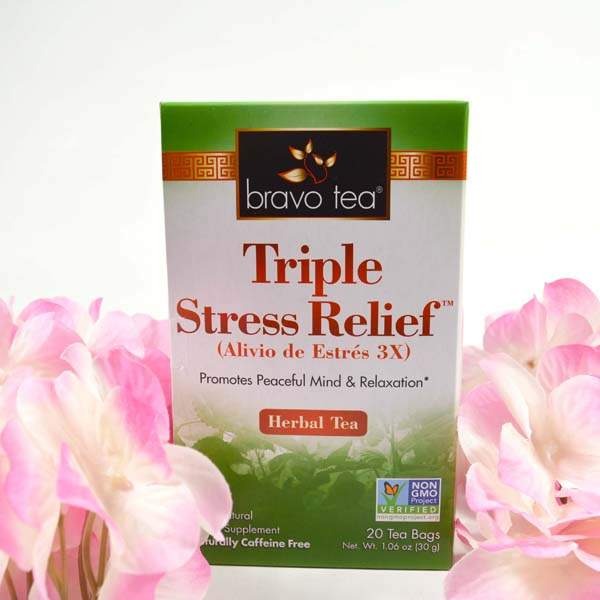 Bravo Tea Triple Stress Relief box standing between pink hydrangea blooms