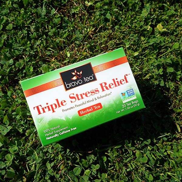 Bravo Tea Triple Stress Relief herbal tea box tilted on green clover
