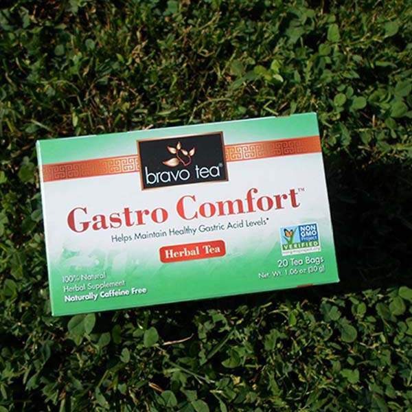Bravo Tea Gastro Comfort herbal tea box lying on green clover