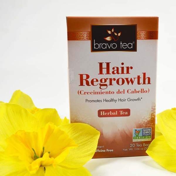 Bravo Tea Hair Regrowth box standing between yellow daffodils