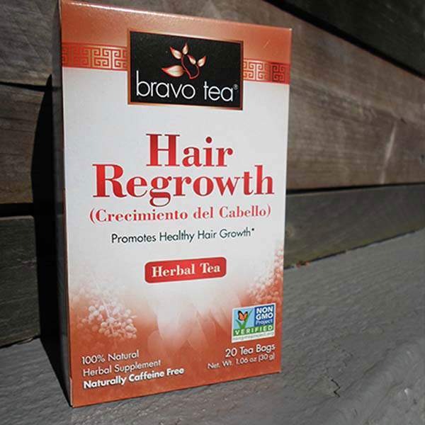 Bravo Tea Hair Regrowth box standing on a weathered wooden ledge