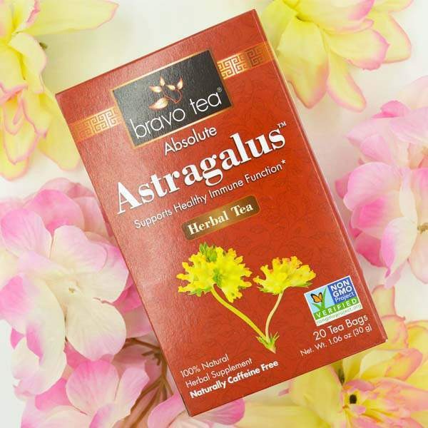 Bravo Tea Absolute Astragalus box lying among pink and yellow flowers