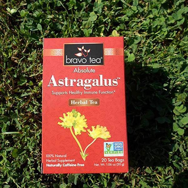 Bravo Tea Absolute Astragalus herbal tea box standing on green clover