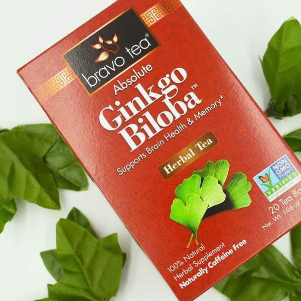 Bravo Tea Absolute Ginkgo Biloba box angled on green leaves, front showing the ginkgo leaf illustration