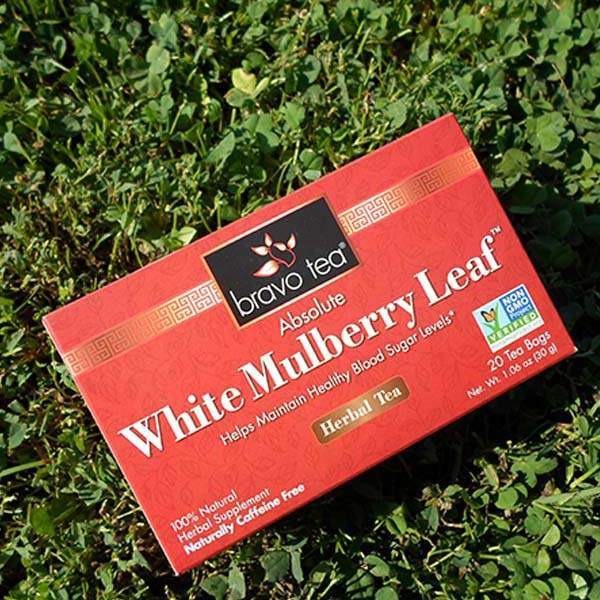 Bravo Tea Absolute White Mulberry Leaf box lying at an angle on green clover