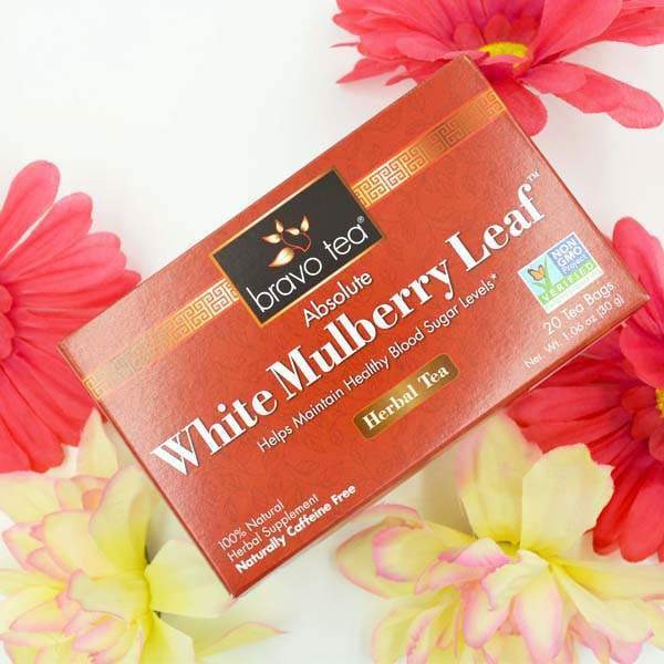 Bravo Tea Absolute White Mulberry Leaf box laid flat on a white surface with pink and yellow flowers