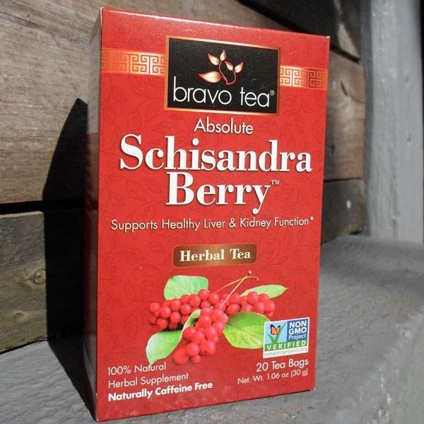 Bravo Tea Absolute Schisandra Berry box standing upright on a wooden step, front panel with red berry artwork
