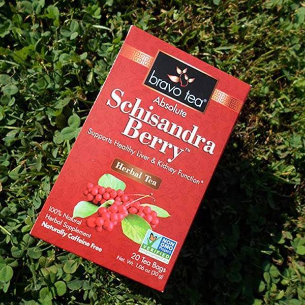 Bravo Tea Absolute Schisandra Berry box lying on green clover in sunlight