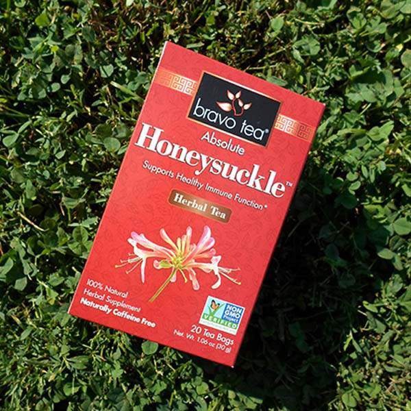 Bravo Tea Absolute Honeysuckle box lying diagonally on green clover
