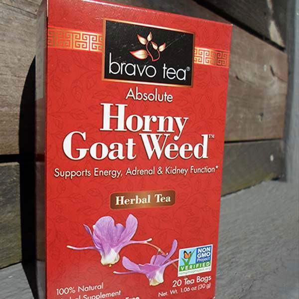 Bravo Tea Absolute Horny Goat Weed box upright against weathered wood, front panel with purple epimedium flower artwork