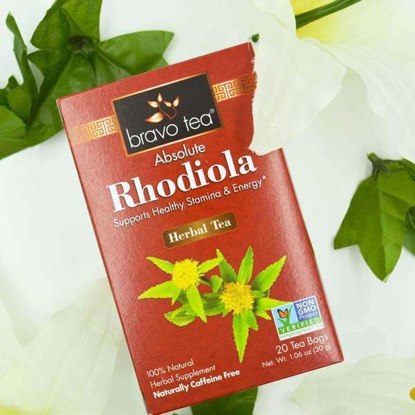 Bravo Tea Absolute Rhodiola box angled among white lilies and green leaves