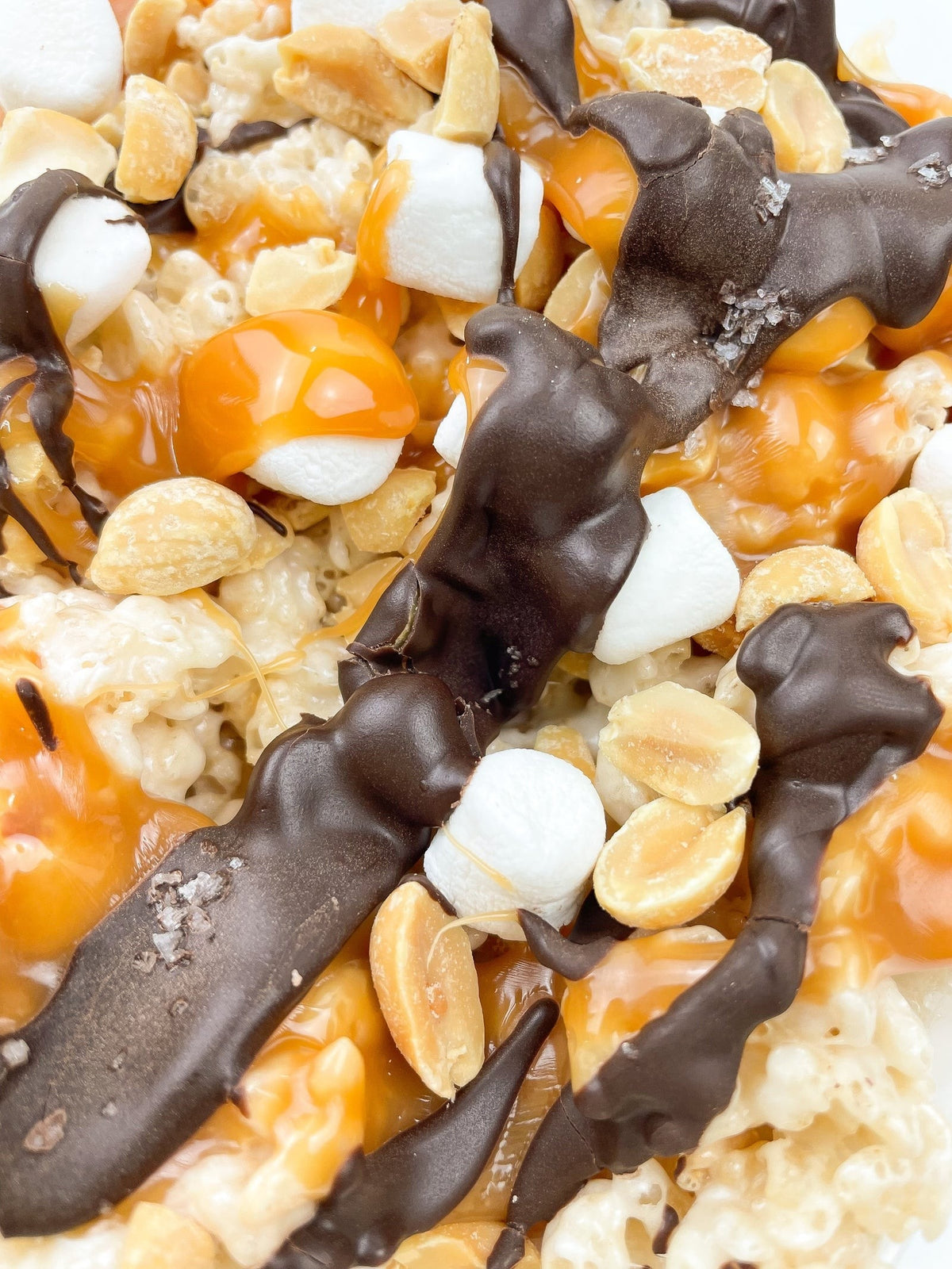 Creative Crispies Co. Dark Chocolate, Caramel, Peanuts & Sea Salt Crispie Clusters styled on a table