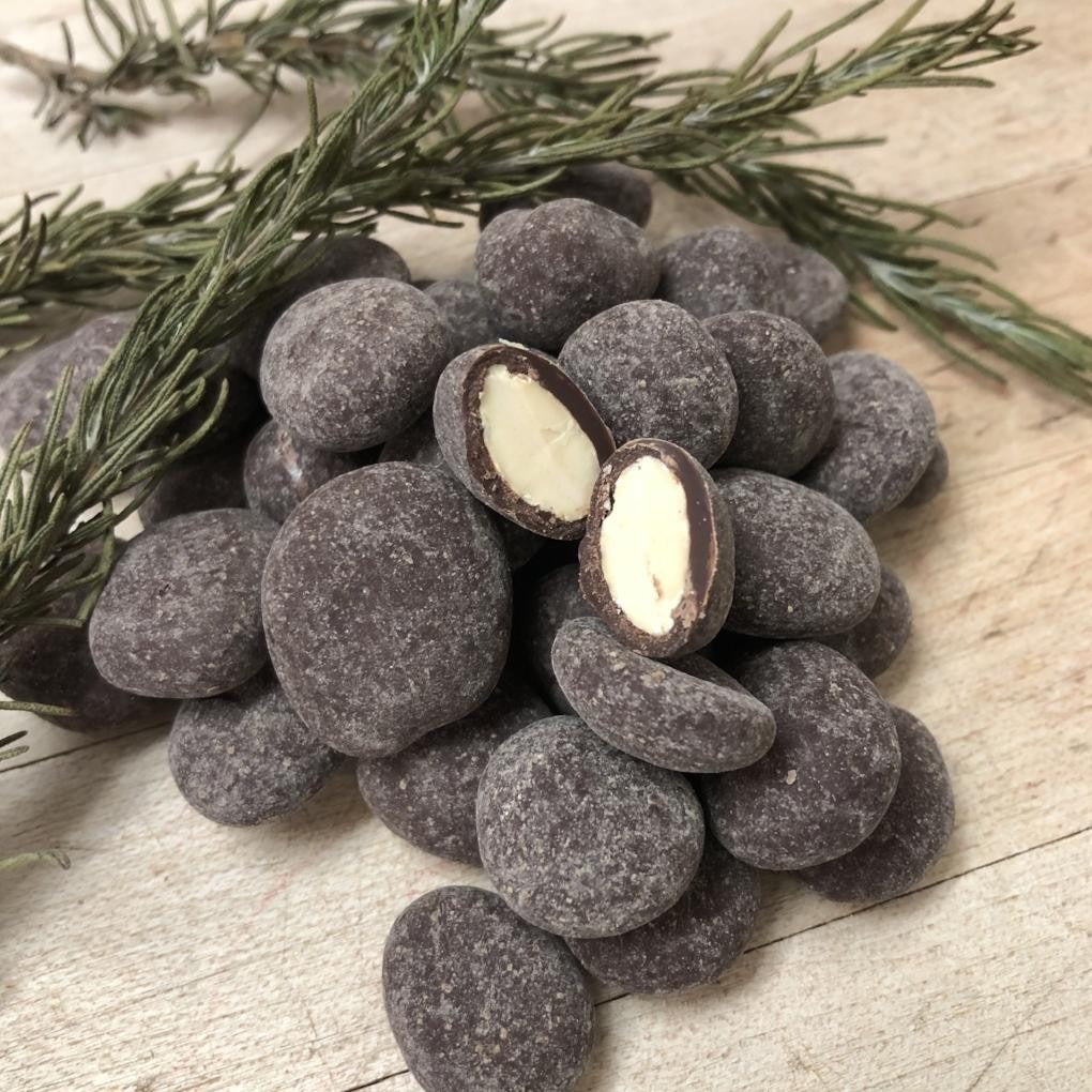 Fruition Chocolate Works Dark Chocolate Marcona Almonds with Rosemary styled on a table
