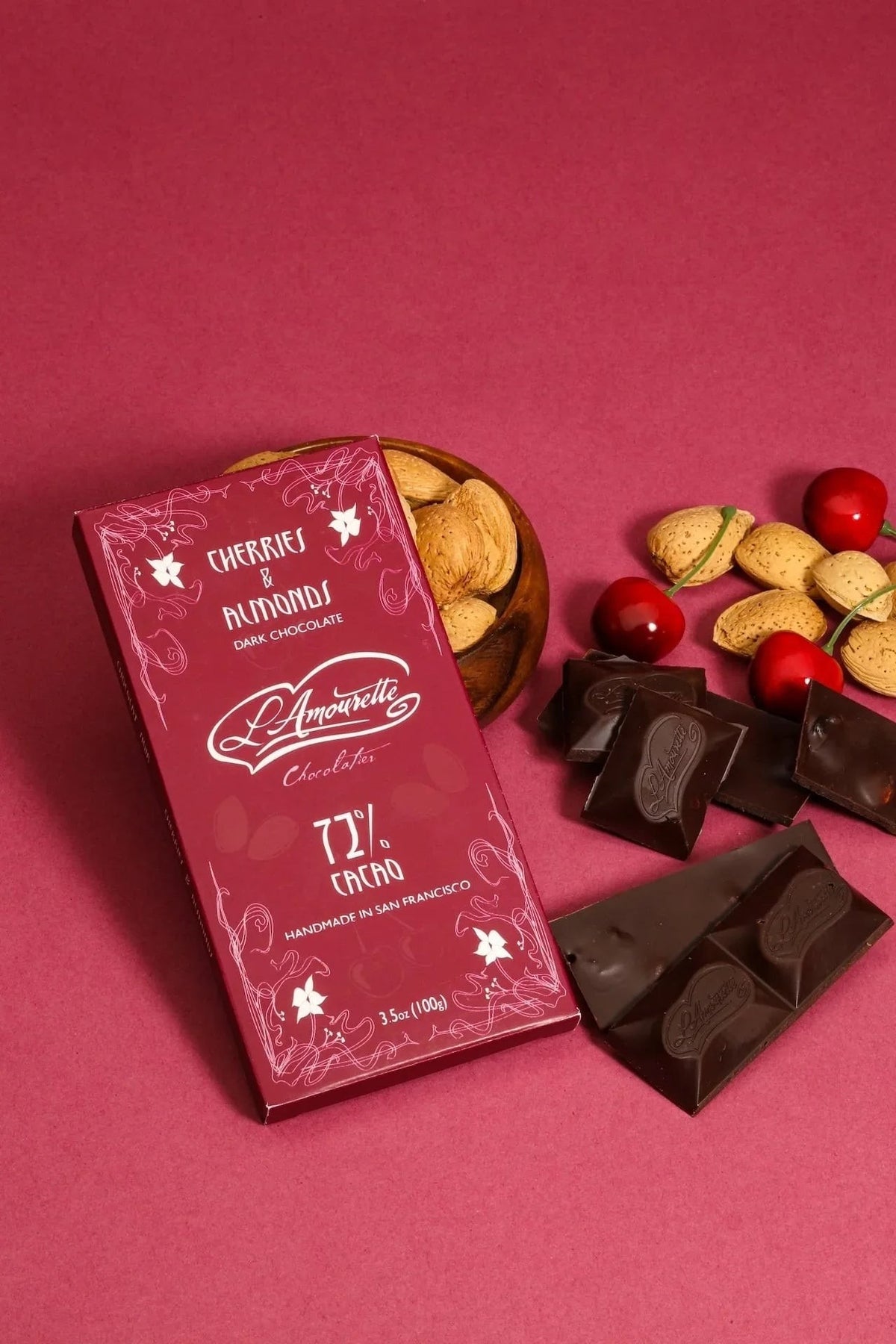 L'Amourette Chocolat 72% Dark Chocolate with Dried Cherries & Salted Almonds Bar styled on a table