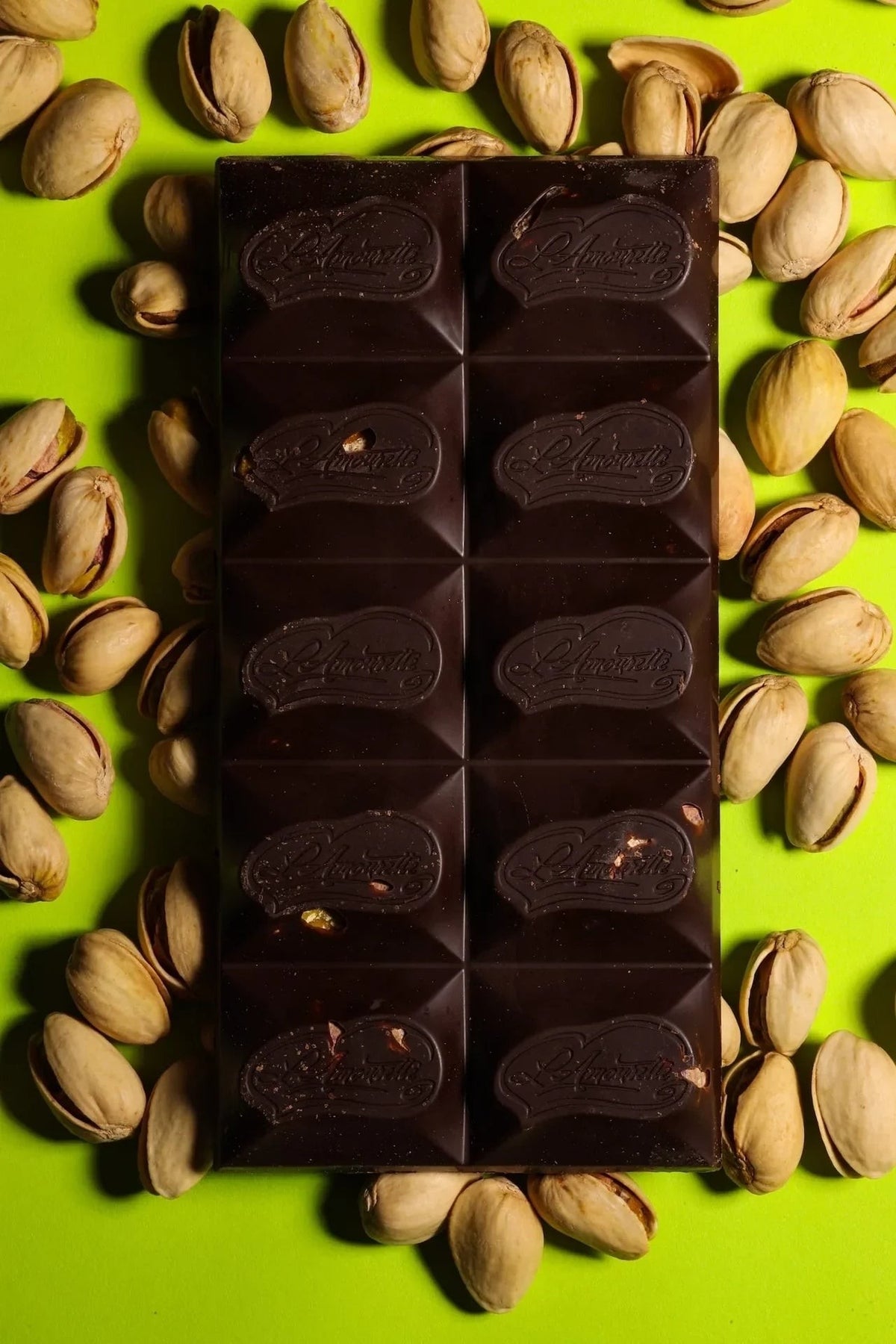 L'Amourette Chocolat 72% Dark Chocolate with Salted Pistachios Bar styled on a table