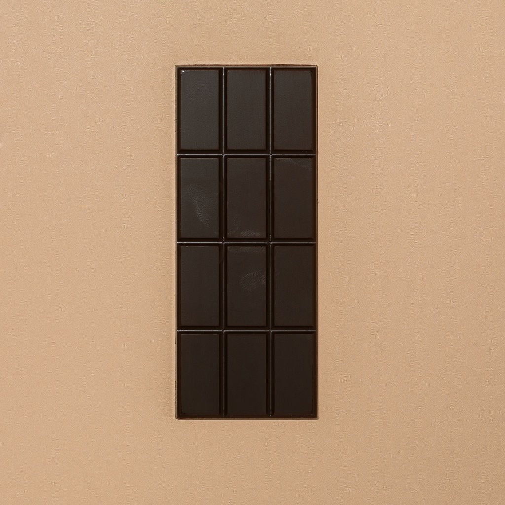 Close-up of Monsoon Chocolate Kokoa Kamili Tanzania 77% Dark Chocolate Bar as it comes out of the package
