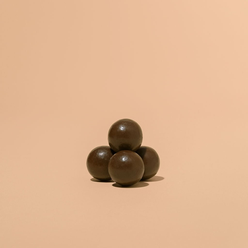 Close-up of Monsoon Chocolate Dark Milk Chocolate Covered Malt Balls as it comes out of the package