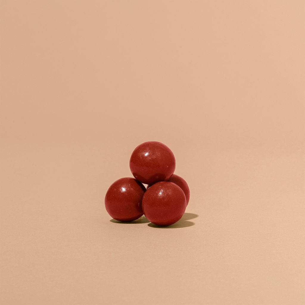 Close-up of Monsoon Chocolate Roasted Strawberry Chocolate Covered Malt Balls as it comes out of the package