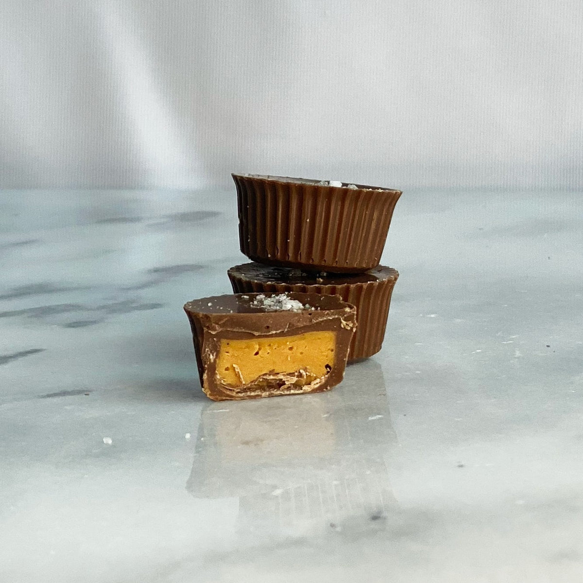 Ragged Coast Chocolates Dark Chocolate Peanut Butter Cups styled on a table