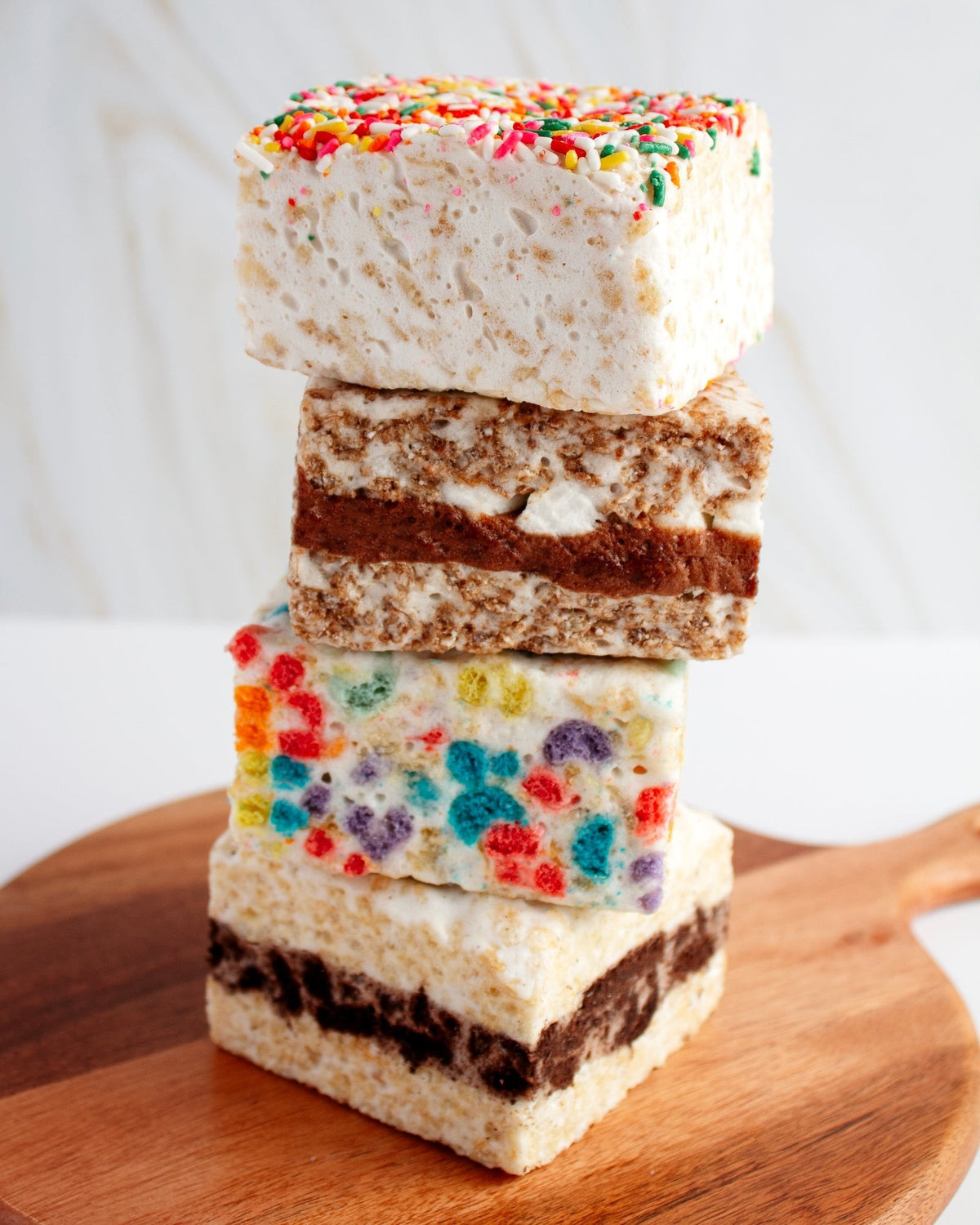 The Crispery Rainbow Sprinkles Crispycake, Marshmallow Crispy Rice Treat styled on a table